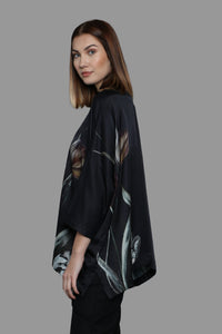 Side pictured of a lady wearing a tulip printed shirt